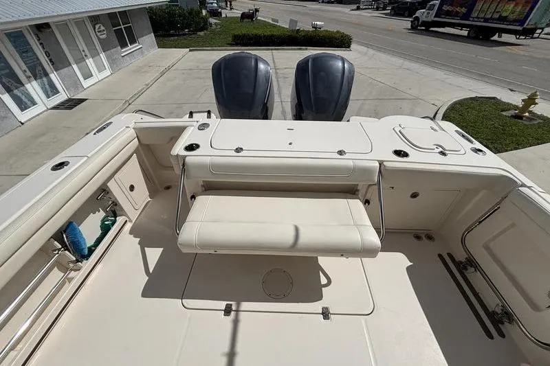 Slide: The Image of 2018 Grady-White Freedom 325 boat with dual engines and spacious seating area. - 23