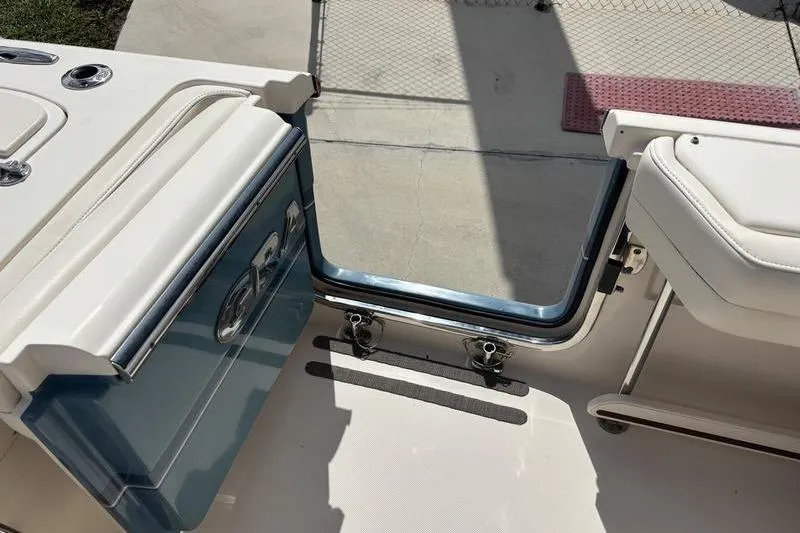 Slide: The Image of 2018 Grady-White Freedom 325 boat interior with open transom door. - 30