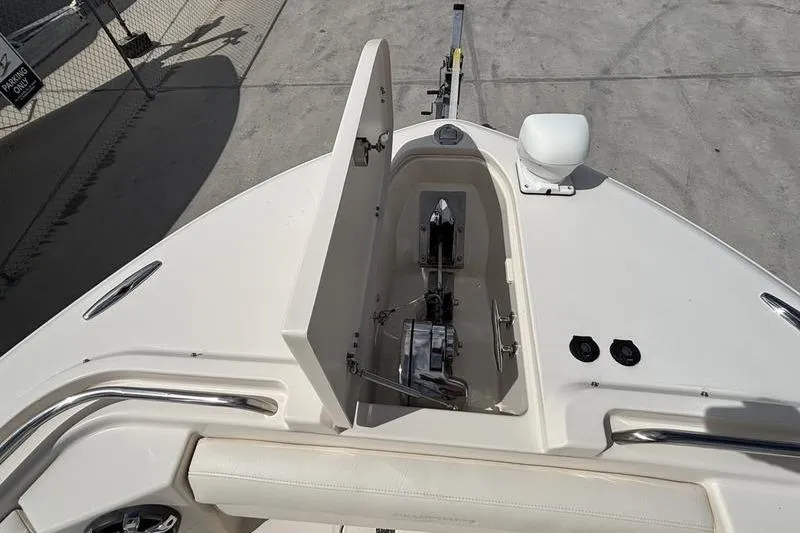 Slide: The Image of 2018 Grady-White Freedom 325 boat anchor compartment, open lid, docked on concrete surface. - 9