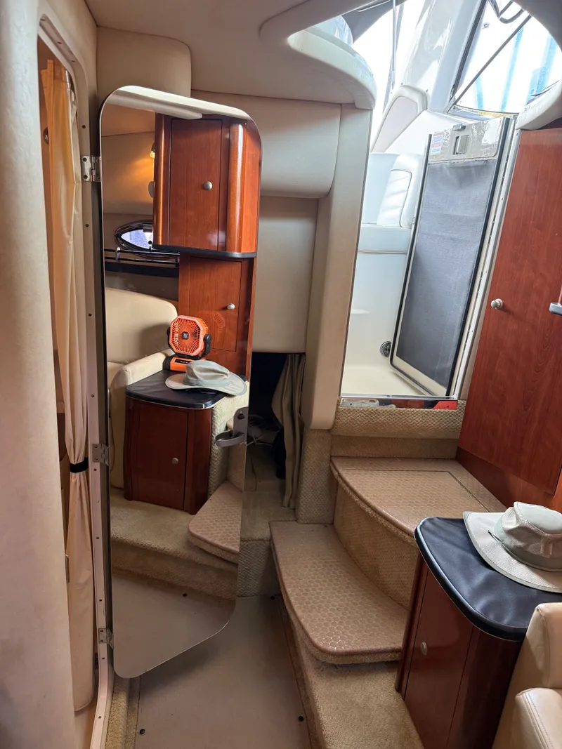 Slide: The Image of Interior of 2007 Sea Ray 290 Sundancer boat with wooden cabinets and carpeted steps. - 10