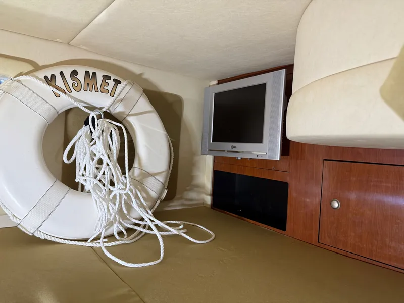 Slide: The Image of 2007 Sea Ray 290 Sundancer cabin with life preserver and wall-mounted TV. - 15