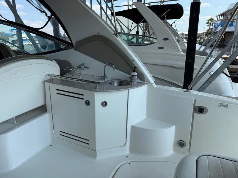 Slide: The Image of 2007 Sea Ray 290 Sundancer boat interior with sink and seating area. - 18