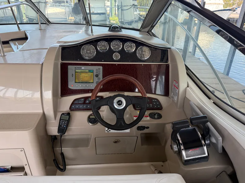 Slide: The Image of Helm of 2007 Sea Ray 290 Sundancer with steering wheel, gauges, and navigation system. - 19