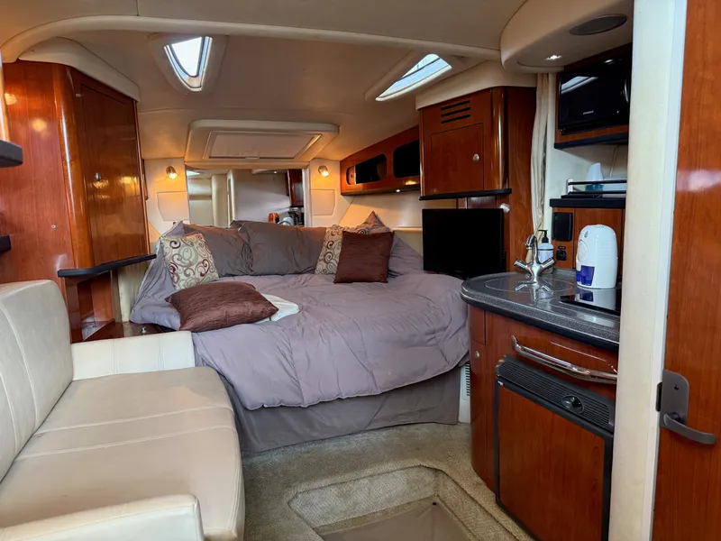 Slide: The Image of Luxurious interior of 2007 Sea Ray 290 Sundancer with cozy bed and kitchenette. - 2