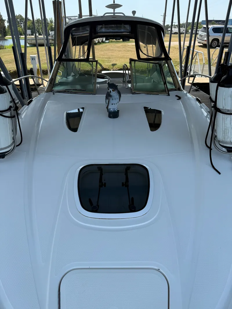 Slide: The Image of 2007 Sea Ray 290 Sundancer boat docked, featuring sleek white deck and tinted windows. - 22