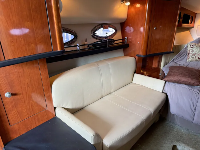 Slide: The Image of Interior of 2007 Sea Ray 290 Sundancer with beige sofa and wooden cabinetry. - 3