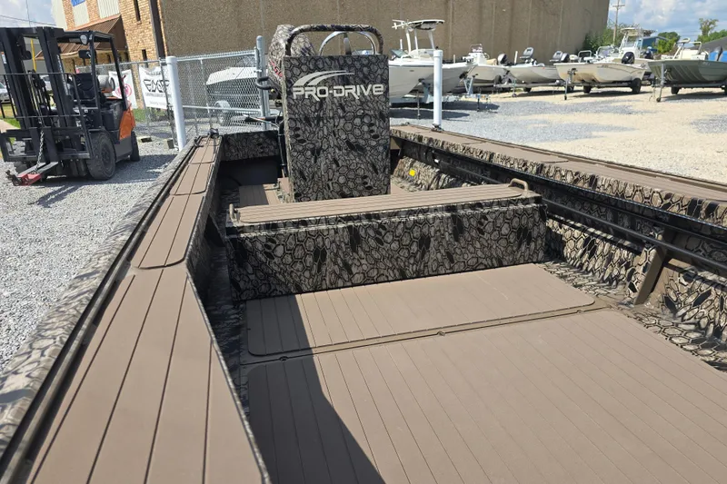 Slide: The Image of 2026 Pro-Drive 2054 X Series TD boat with camouflage design, parked outdoors. - 10