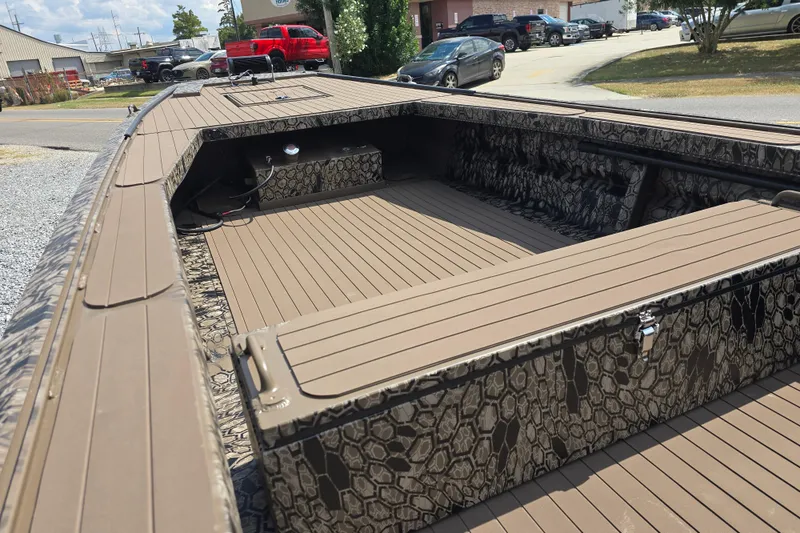 Slide: The Image of 2026 Pro-Drive 2054 X Series TD boat with camouflage interior, parked outdoors. - 12
