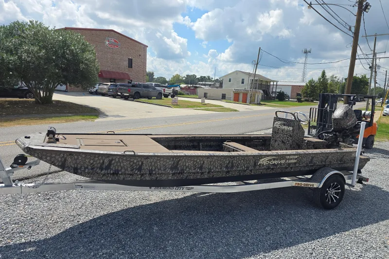 Slide: The Image of 2026 Pro-Drive 2054 X Series TD boat on trailer, parked outdoors. - 2