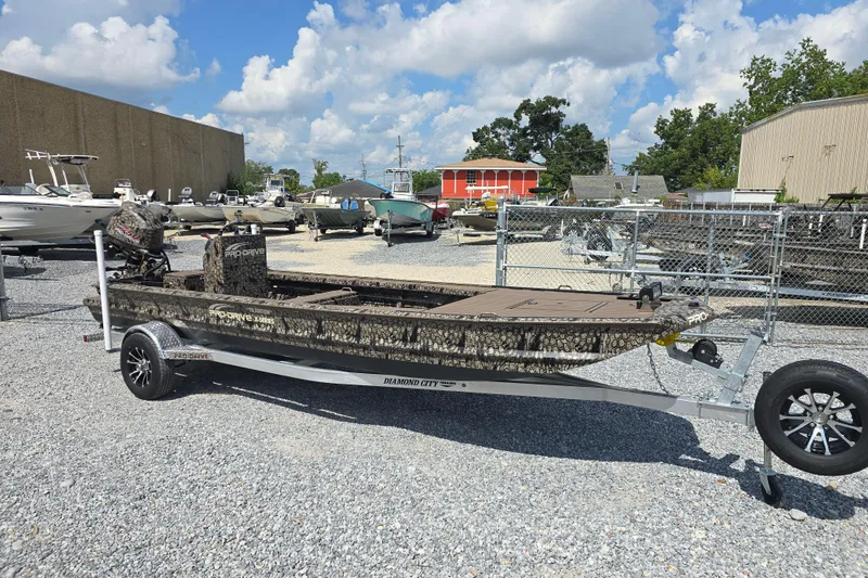 Slide: The Image of 2026 Pro-Drive 2054 X Series TD boat on trailer, parked in a gravel lot. - 4