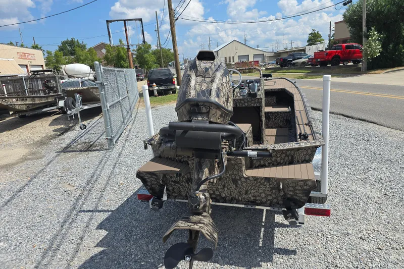 Slide: The Image of 2026 Pro-Drive 2054 X Series TD boat with camouflage design on gravel lot. - 7