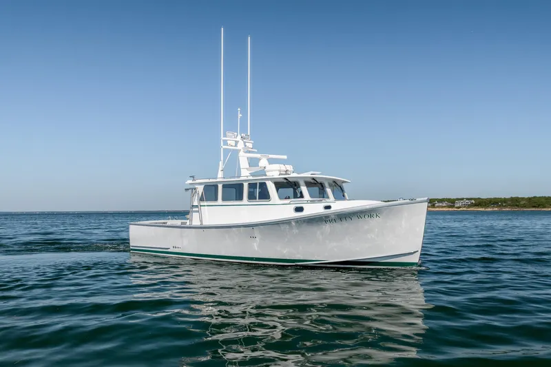 Slide: The Image of 2025 Mussel Ridge 42 boat on calm ocean waters under clear blue sky. - 2