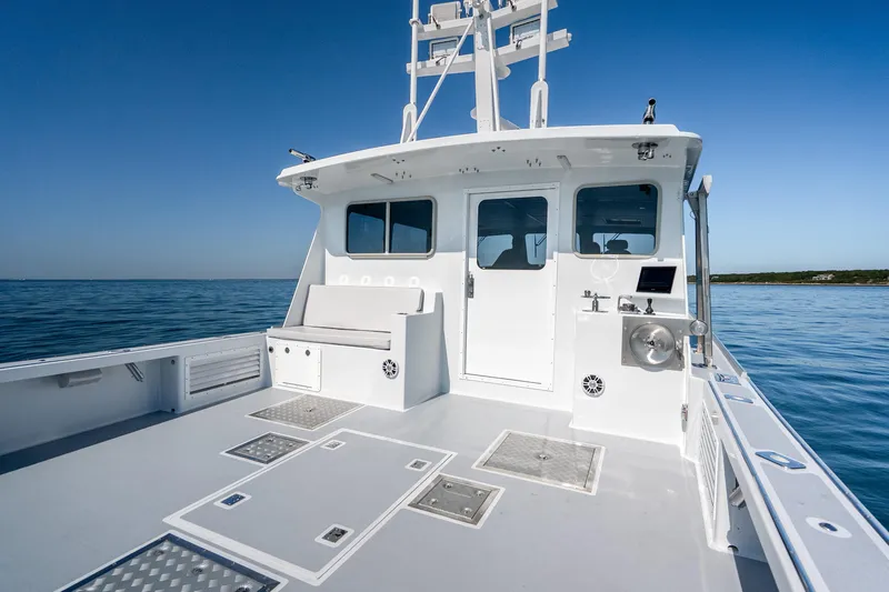 Slide: The Image of 2025 Mussel Ridge 42 boat on calm water, featuring spacious deck and modern design. - 20