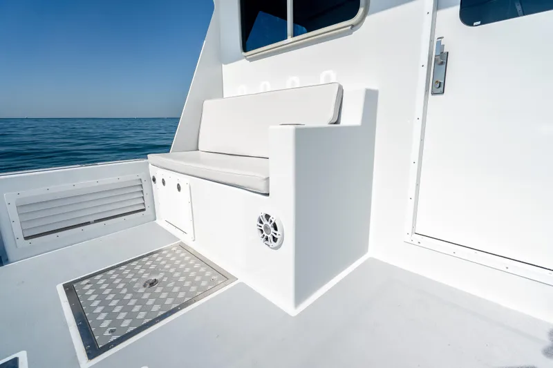 Slide: The Image of 2025 Mussel Ridge 42 boat deck with seating, ocean view, and clear sky. - 22