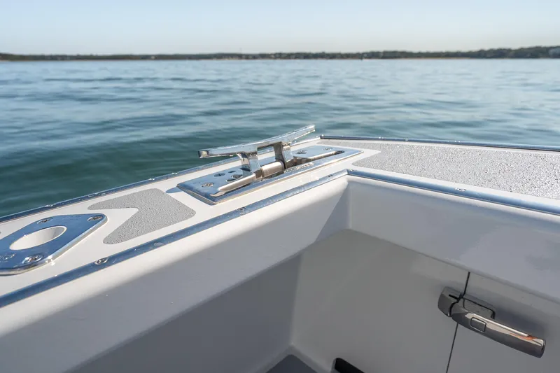 Slide: The Image of 2025 Mussel Ridge 42 boat detail with cleat, on calm water background. - 25