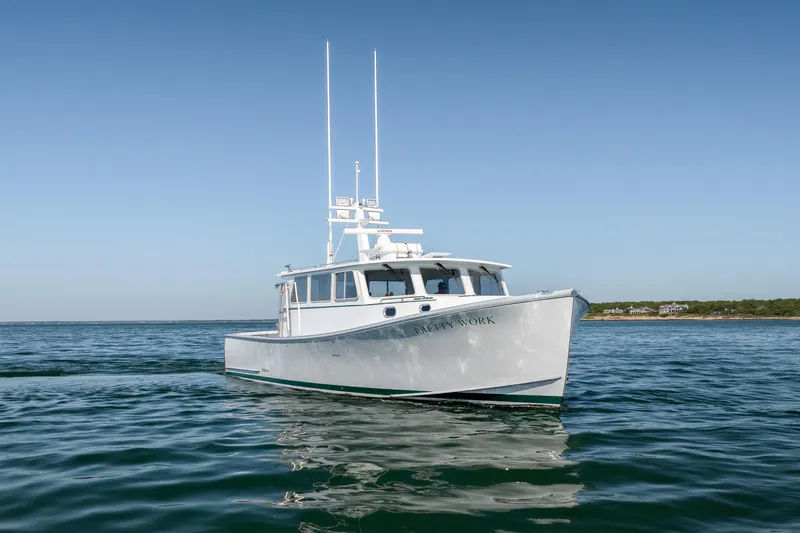 Slide: The Image of 2025 Mussel Ridge 42 boat on calm ocean waters under clear blue sky. - 3