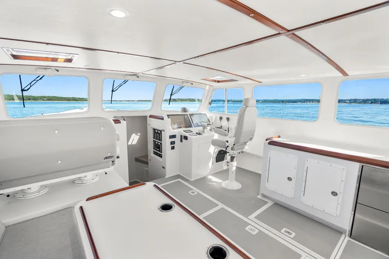 Slide: The Image of Interior of 2025 Mussel Ridge 42 boat with modern helm and panoramic windows. - 31