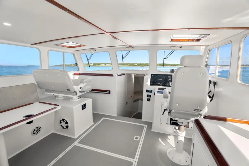 Slide: The Image of Interior of 2025 Mussel Ridge 42 boat with modern helm and seating. - 32