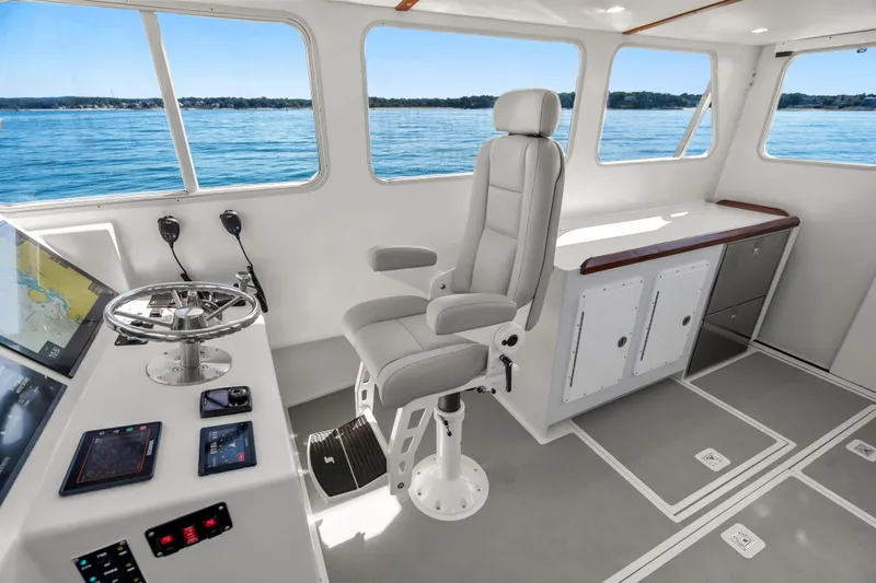 Slide: The Image of Modern helm of 2025 Mussel Ridge 42 boat with sleek controls and panoramic windows. - 33