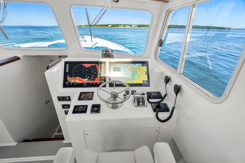 Slide: The Image of Helm of 2025 Mussel Ridge 42 boat with navigation screens and ocean view. - 38