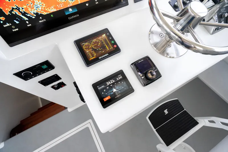 Slide: The Image of Control panel of 2025 Mussel Ridge 42 boat with advanced navigation displays. - 39