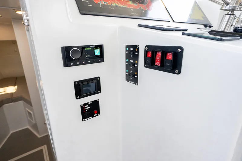Slide: The Image of Control panel of 2025 Mussel Ridge 42 boat with navigation and switch controls. - 40