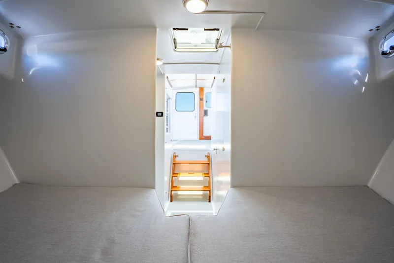 Slide: The Image of Interior cabin of 2025 Mussel Ridge 42 boat, featuring modern design and cozy sleeping area. - 45
