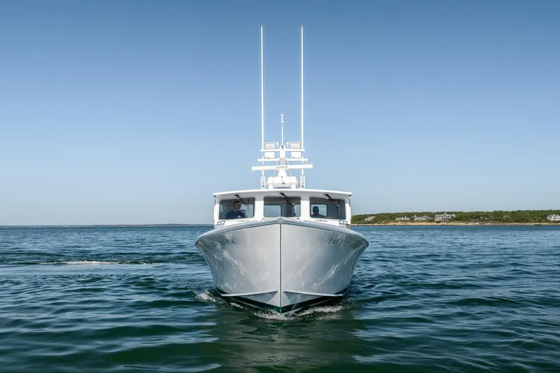 Slide: The Image of 2025 Mussel Ridge 42 boat cruising on calm ocean waters under clear blue sky. - 5