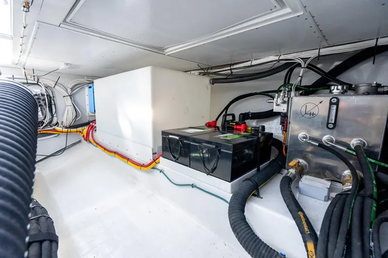Slide: The Image of Engine room of 2025 Mussel Ridge 42 boat with batteries and wiring. - 55