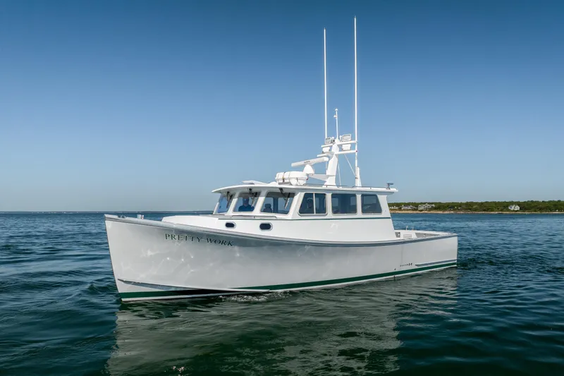 Slide: The Image of 2025 Mussel Ridge 42 boat on calm water under clear blue sky. - 6