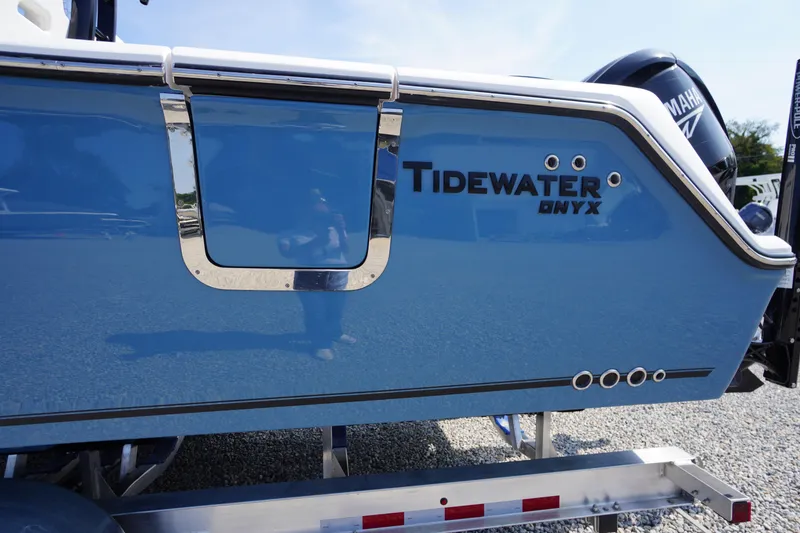 Slide: The Image of 2026 Tidewater 302 CC Adventure boat in blue, featuring Onyx branding. - 1