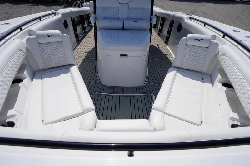 Slide: The Image of 2026 Tidewater 302 CC Adventure boat interior with luxurious white seating and sleek design. - 11