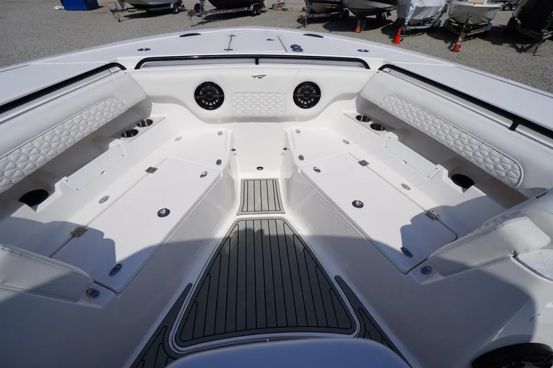 Slide: The Image of 2026 Tidewater 302 CC Adventure boat interior with white seating and storage compartments. - 17