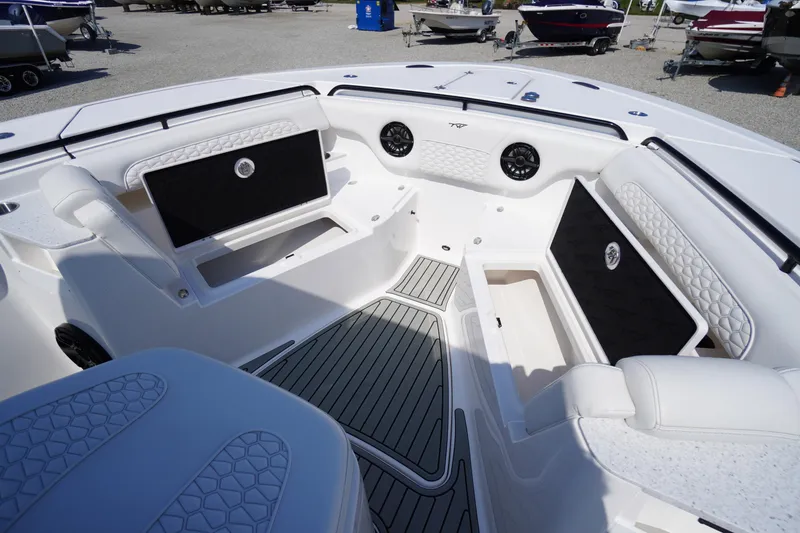 Slide: The Image of 2026 Tidewater 302 CC Adventure boat interior with cushioned seating and storage compartments. - 19
