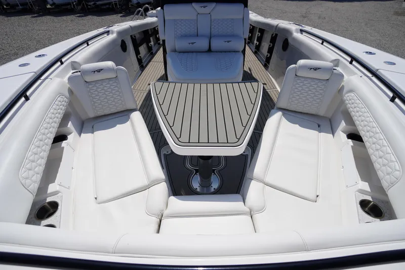 Slide: The Image of 2026 Tidewater 302 CC Adventure boat interior with luxurious seating and sleek table design. - 21