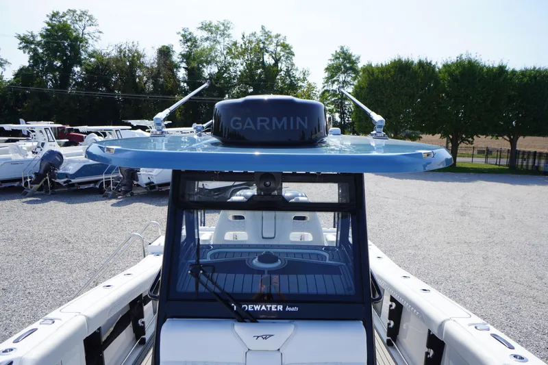 Slide: The Image of 2026 Tidewater 302 CC Adventure boat with Garmin radar, parked outdoors. - 23