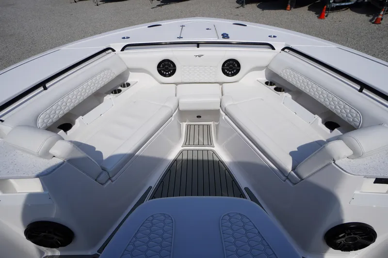 Slide: The Image of Luxurious seating area on 2026 Tidewater 302 CC Adventure boat, featuring white upholstery and cup holders. - 3