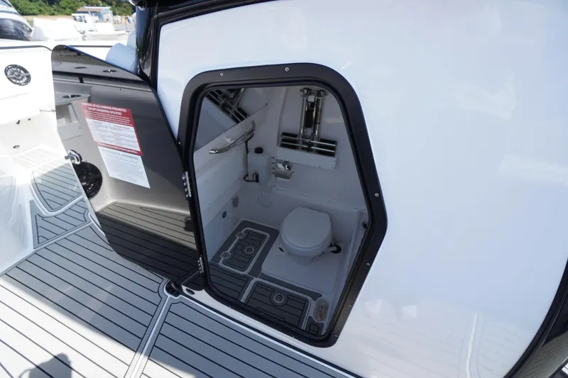Slide: The Image of 2026 Tidewater 302 CC Adventure boat interior with compact marine toilet. - 31