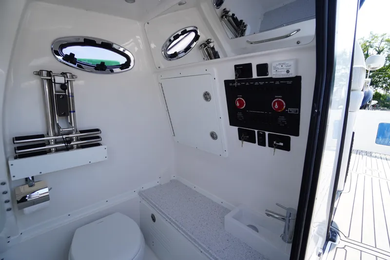 Slide: The Image of Interior of 2026 Tidewater 302 CC Adventure boat, featuring control panel and compact restroom. - 34