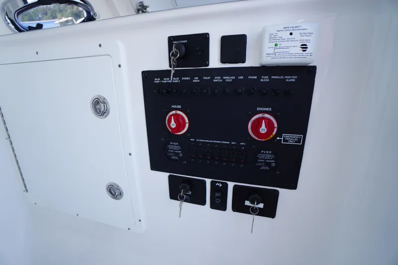 Slide: The Image of Control panel of 2026 Tidewater 302 CC Adventure boat with switches and keys. - 35