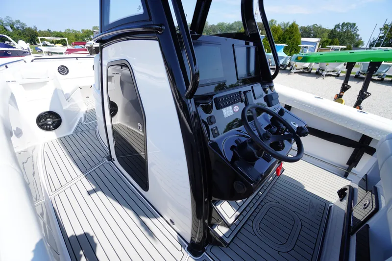 Slide: The Image of 2026 Tidewater 302 CC Adventure boat cockpit with modern steering and control panel. - 38