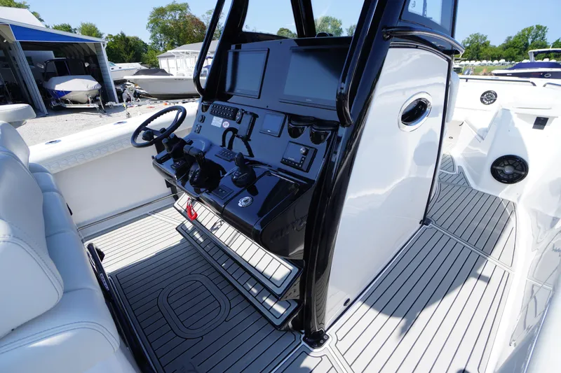 Slide: The Image of 2026 Tidewater 302 CC Adventure boat cockpit with modern controls and sleek design. - 39