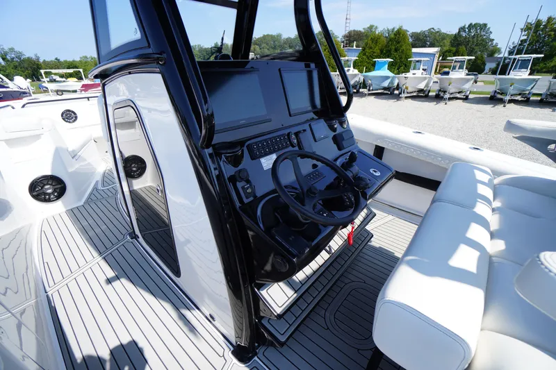 Slide: The Image of 2026 Tidewater 302 CC Adventure boat cockpit with modern controls and seating. - 41