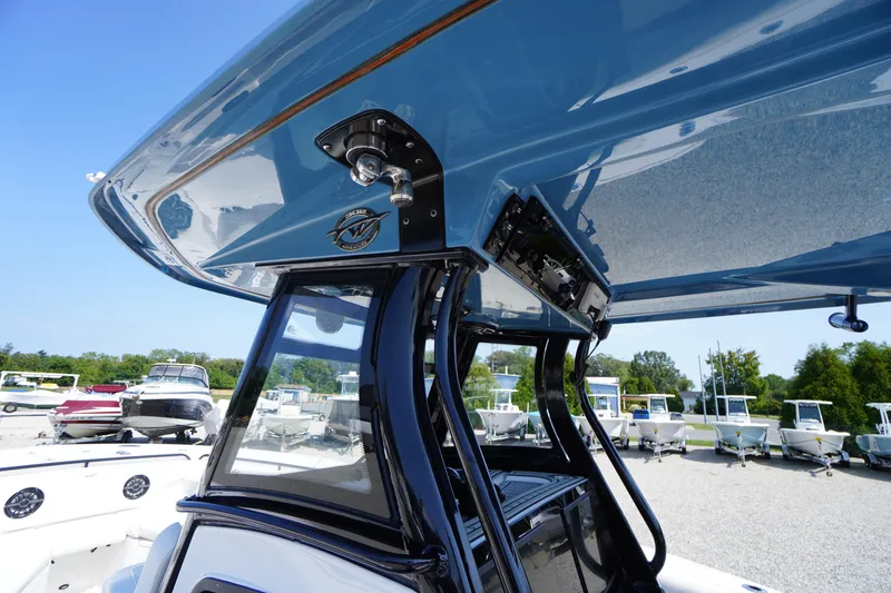 Slide: The Image of 2026 Tidewater 302 CC Adventure boat with sleek blue canopy and modern design. - 45