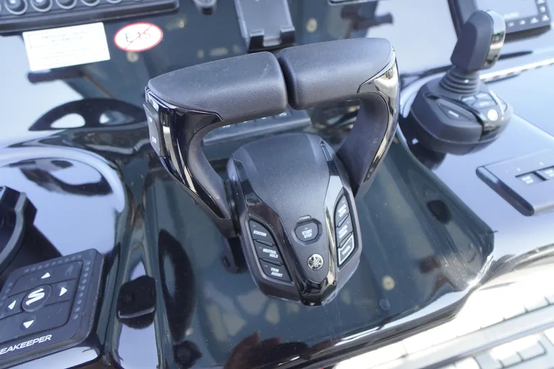 Slide: The Image of Close-up of 2026 Tidewater 302 CC Adventure boat controls and throttle. - 48