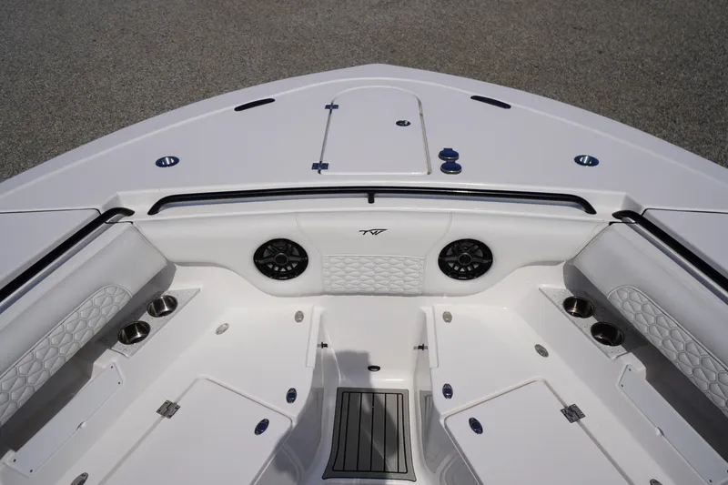 Slide: The Image of 2026 Tidewater 302 CC Adventure boat interior with cushioned seating and cup holders. - 5