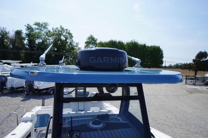 Slide: The Image of 2026 Tidewater 302 CC Adventure boat with Garmin radar on blue hardtop. - 50