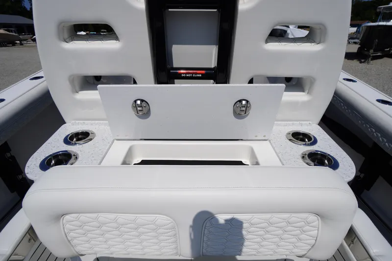 Slide: The Image of 2026 Tidewater 302 CC Adventure boat interior with seating and cup holders. - 54