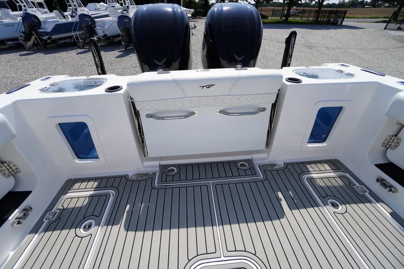 Slide: The Image of 2026 Tidewater 302 CC Adventure boat deck with dual engines and sleek design. - 60