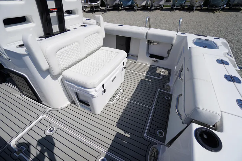 Slide: The Image of 2026 Tidewater 302 CC Adventure boat interior with cushioned seating and sleek deck design. - 62